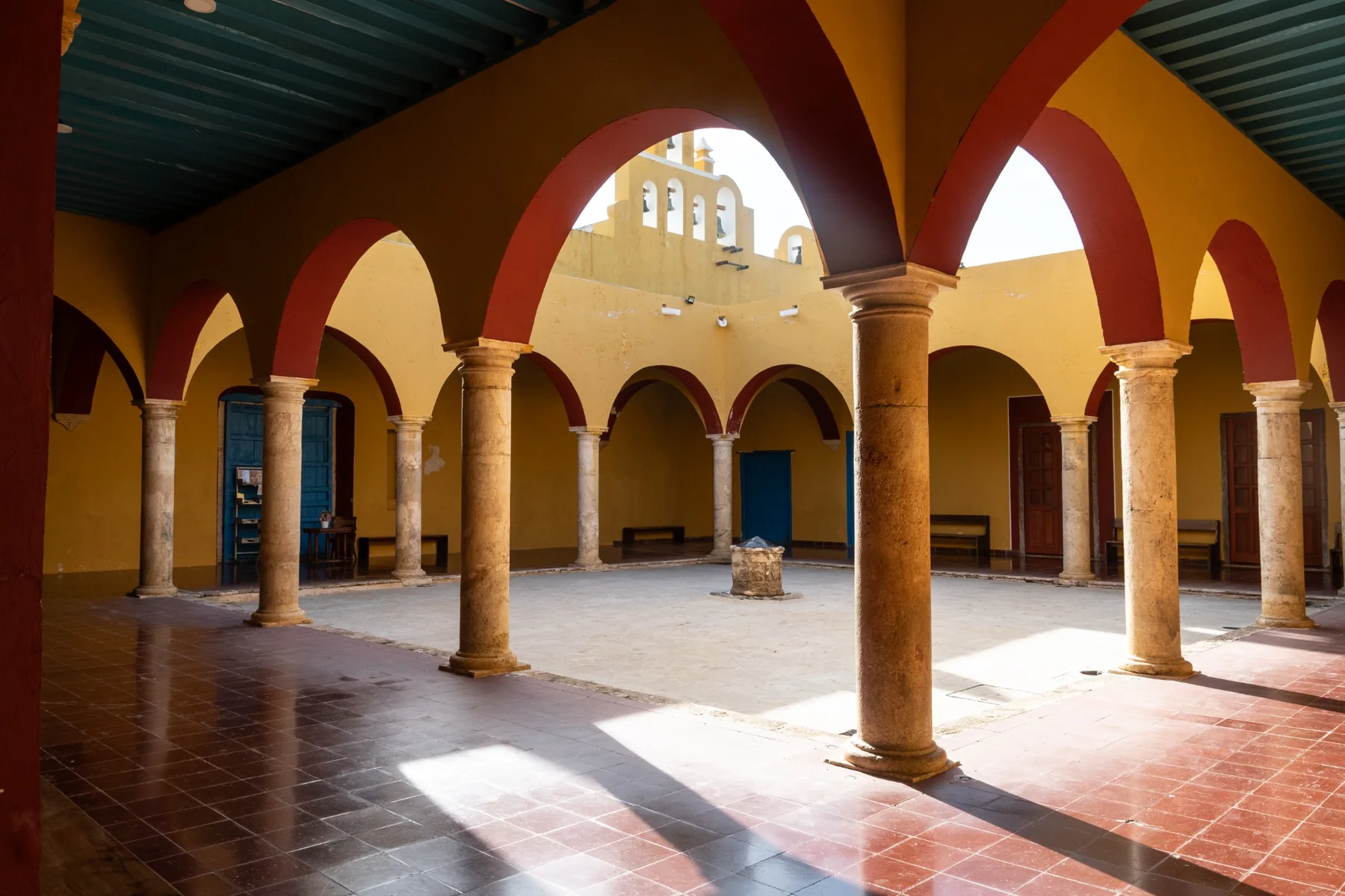 An inner courtyard with arches and columns in a historic building.