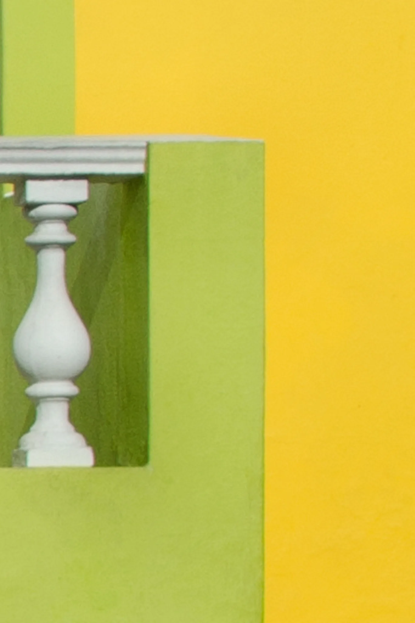 Yellow and green detail with a white balustrade. Yellow and green detail with a white balustrade.
