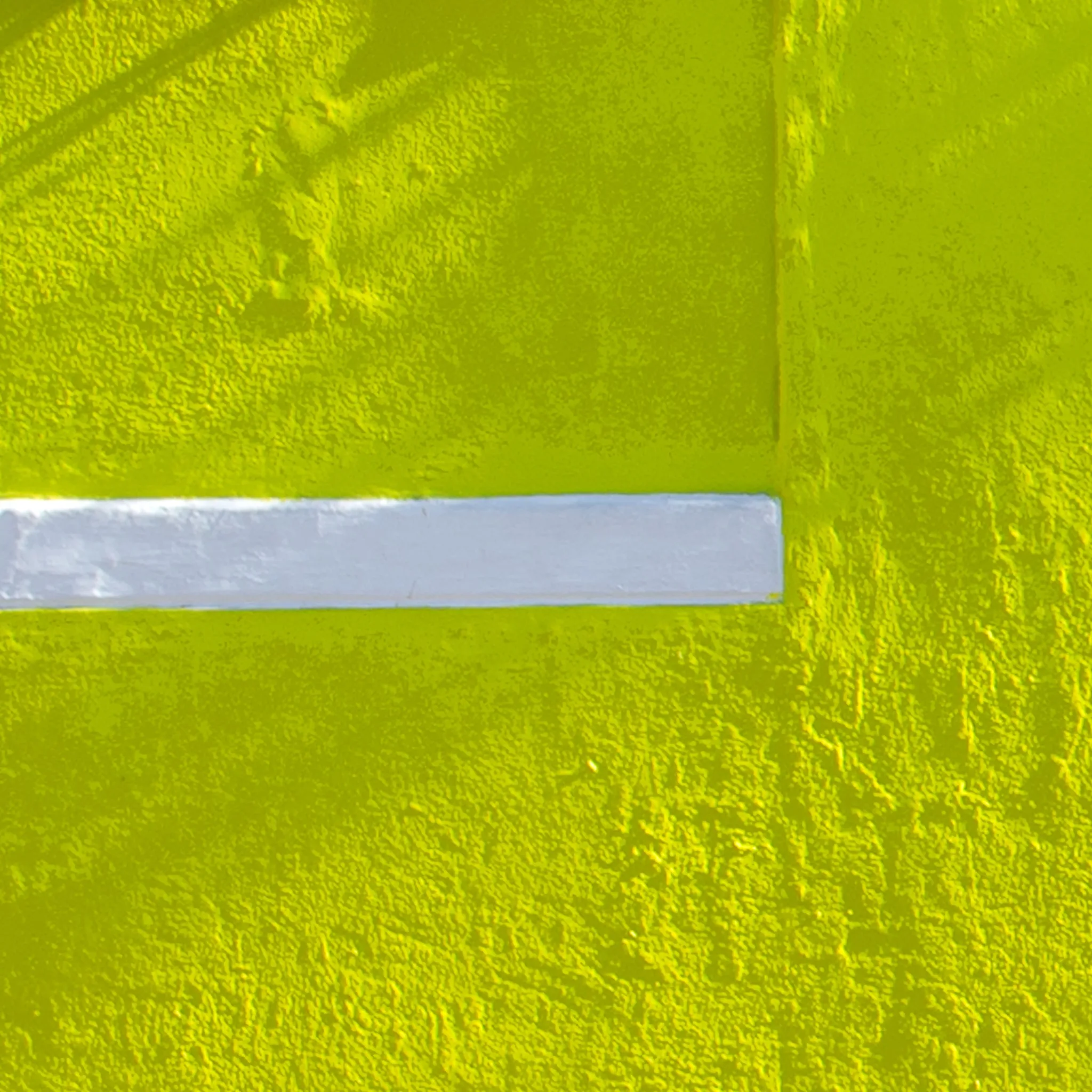 Abstract detail of a yellow wall with a white line. Abstract detail of a yellow wall with a white line.