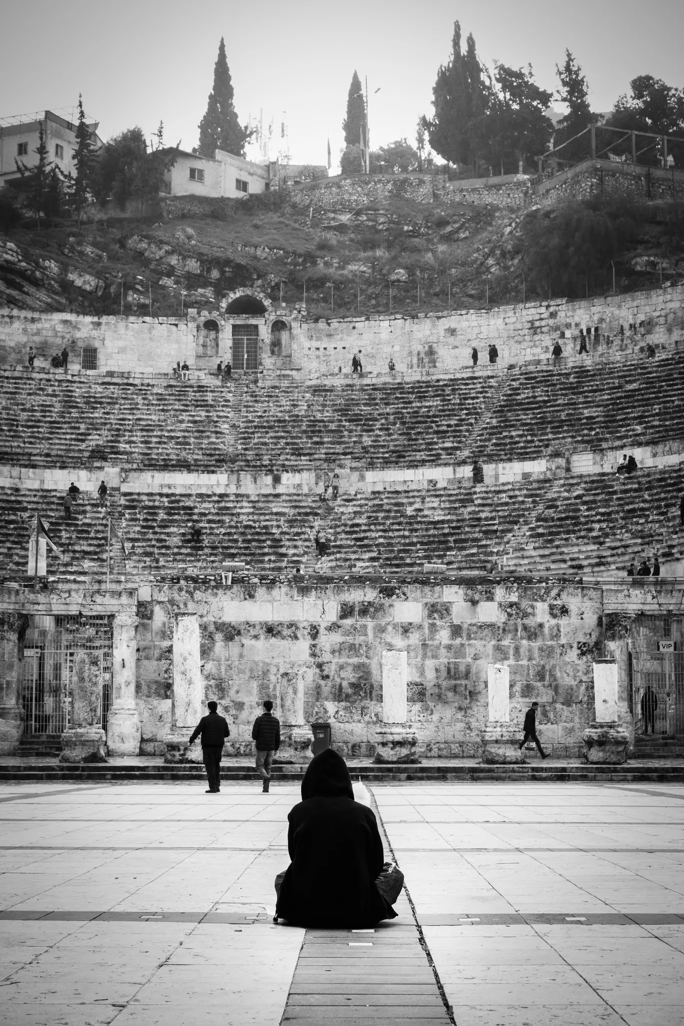 The Roman Theatre in Amman, with small figures crossing its terraces.